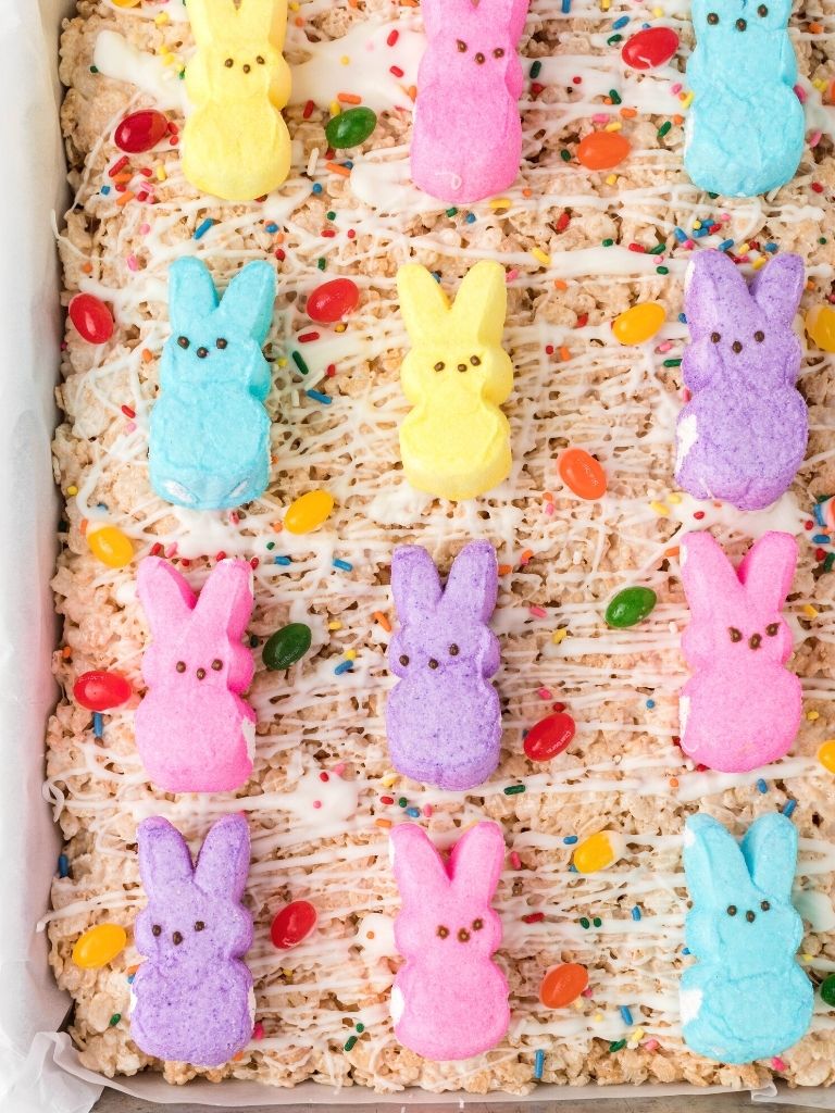 Pan of Easter rice Krispy treats decorated with candy and chocolate.