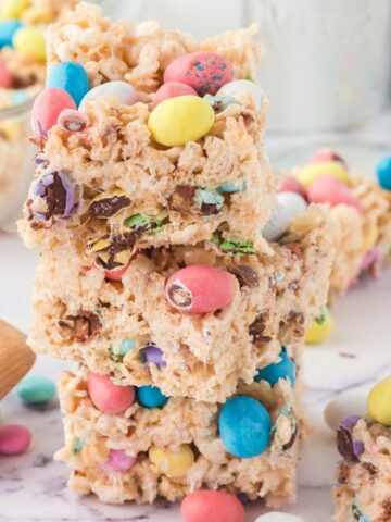 Stack of Krispy treats with candy in them and on top.