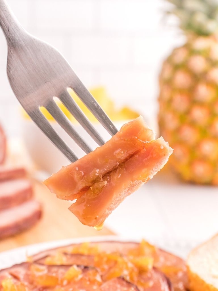 A bite of ham on a fork