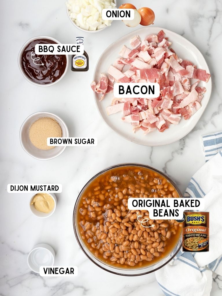 Ingredients needed to make baked beans with canned beans with each one labeled in text with what it is.
