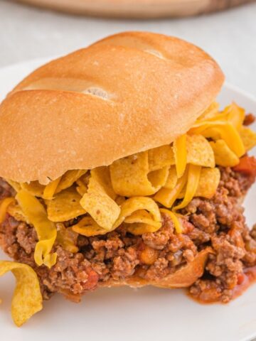 A sloppy Joe with Fritos and cheese on it.