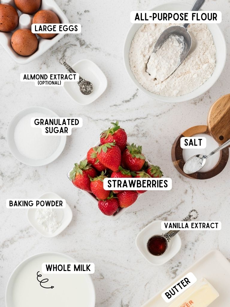Ingredients needed to make strawberry waffles with each ingredient labeled in black text.