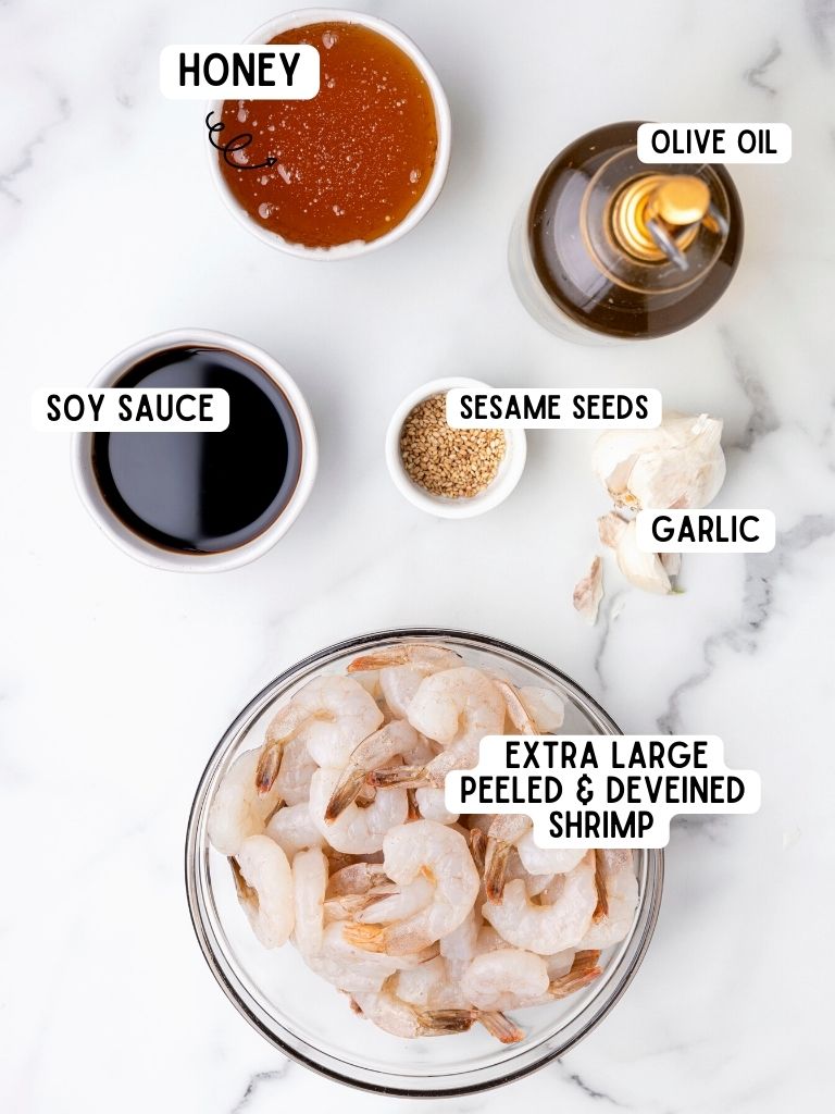 Ingredients for this shrimp recipe with each one labeled in black text with the name of it. 