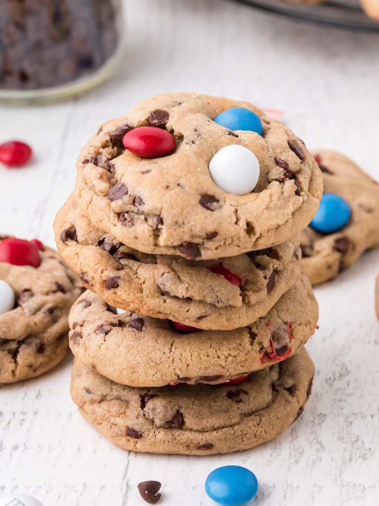 A stack of cookies with red, white, and blue m&m's on top of it. 