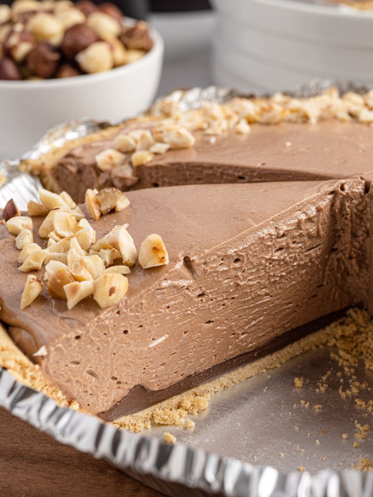 Side view inside a tin foil pie plate with a Nutella pie. 