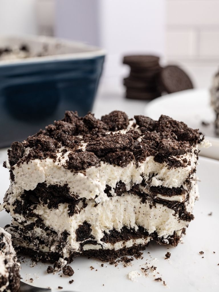 A slice of icebox cake with a fork piece taken out of it to show the inside texture of the cake. 