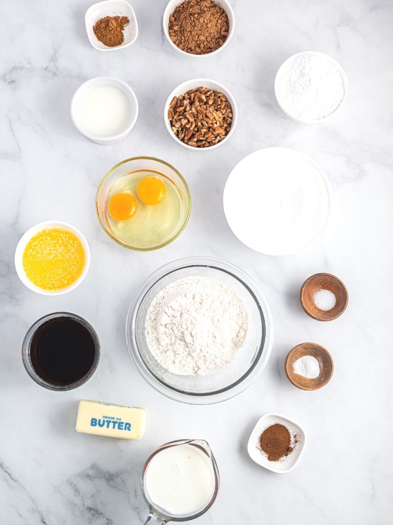 Ingredients on a white background of what you need to make this Texas sheet cake recipe. 