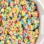 A white dish of cereal treats with Froot Loops cereal.