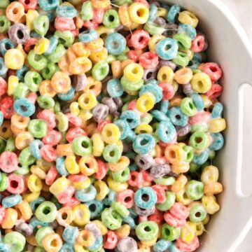 A white dish of cereal treats with Froot Loops cereal.