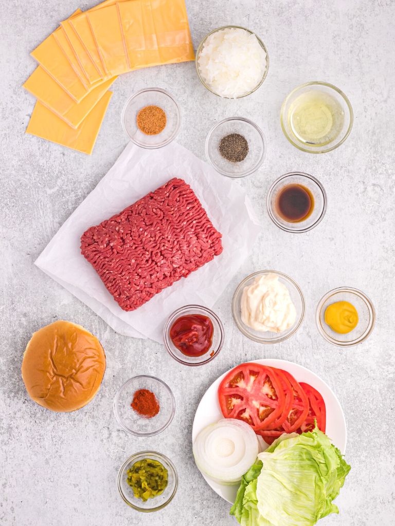Ingredients for in n out copycat burgers on a white background with each one labeled with what it is. 