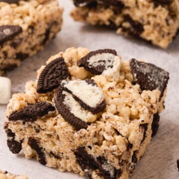 Rice Krispie squares with oreo cookies in them against a white background.