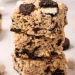A stack of Krispie treats with Oreo cookies and mini marshmallows.