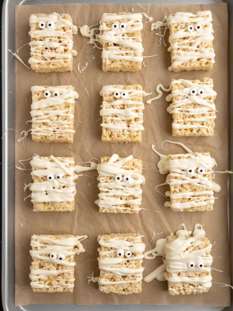 A cookie sheet of mummy treats made with Rice Krispies. 