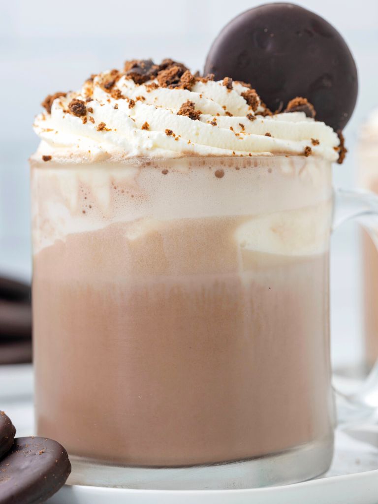 Close up shot of a glass mug of hot chocolate.