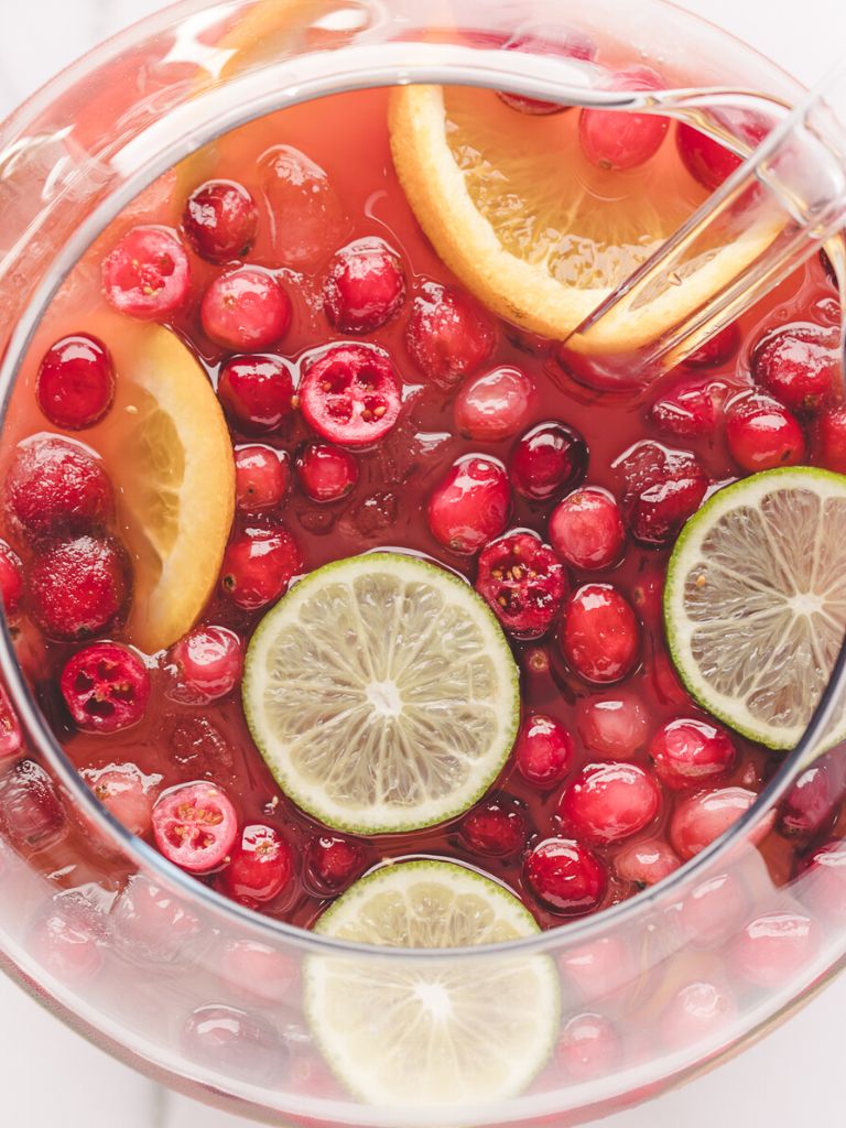 Overhead shot of a punch bowl with punch inside of it and a ladle.