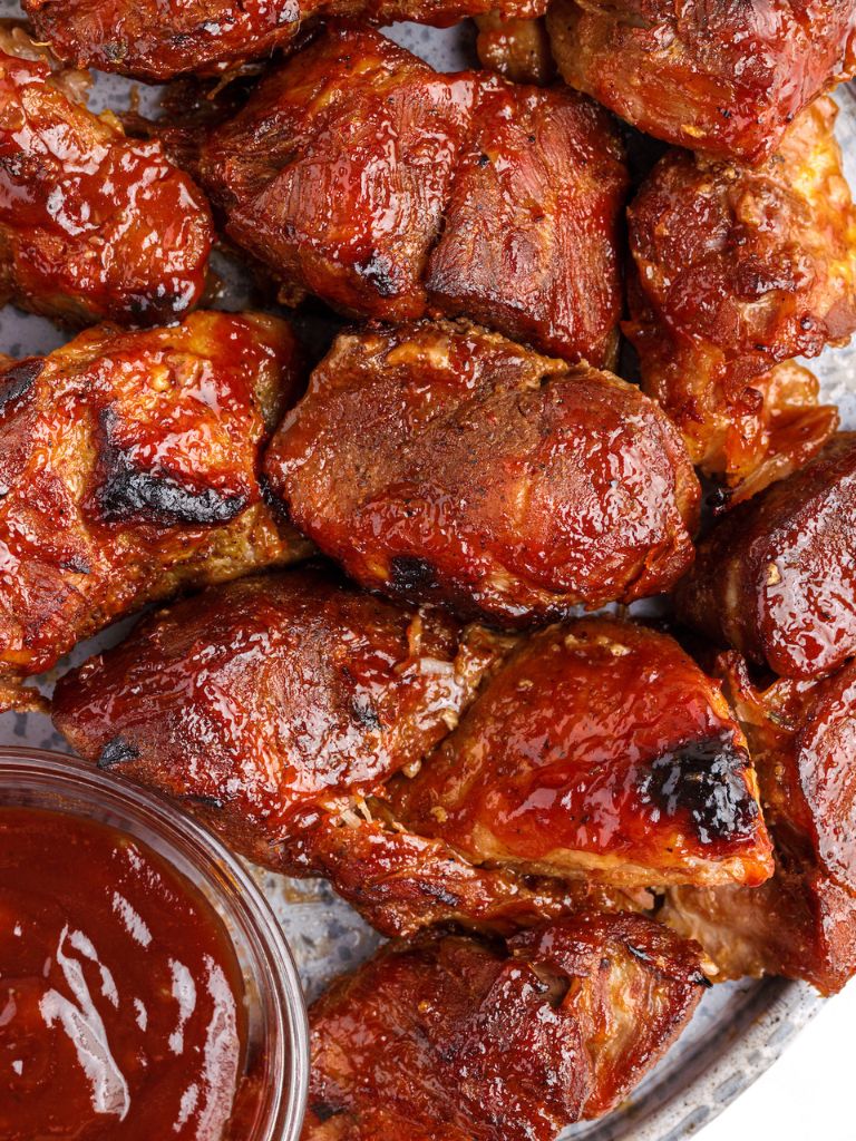 A plate of boneless pork ribs rubbed in bbq sauce and baked.