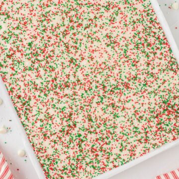 Pan of fudge with sprinkles and ribbon on the side of the pan.
