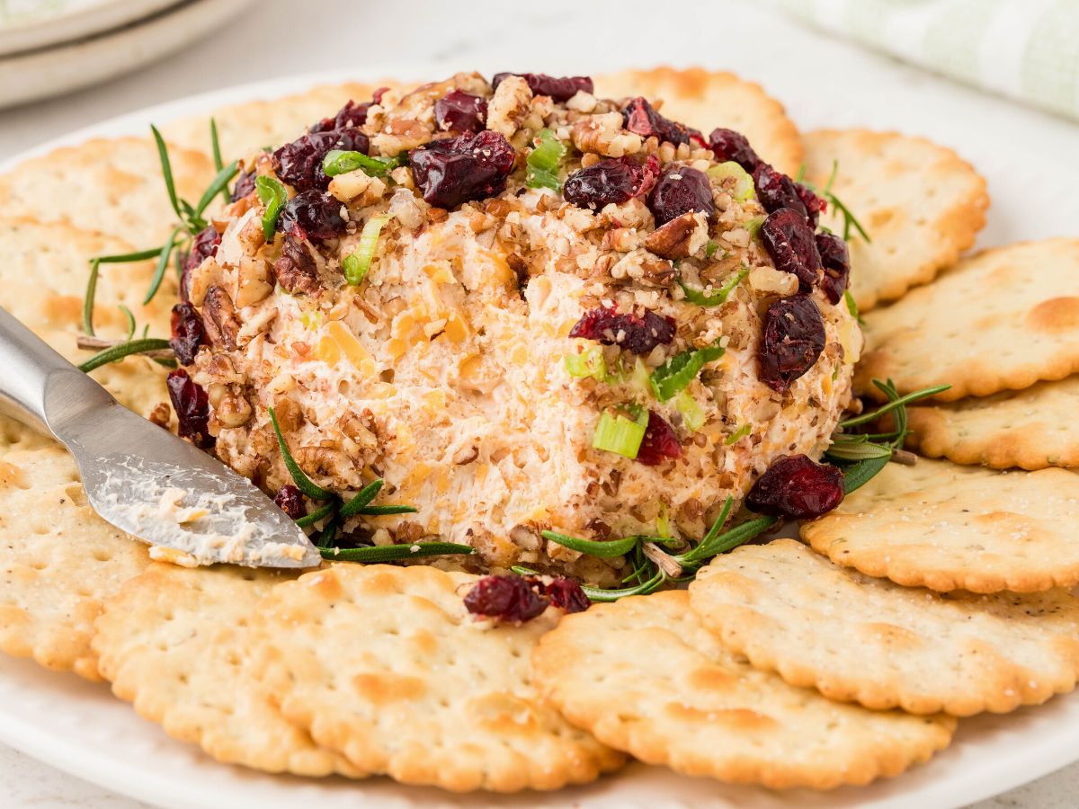 Horizontal photo of a decorated cheeseball for the Holidays.