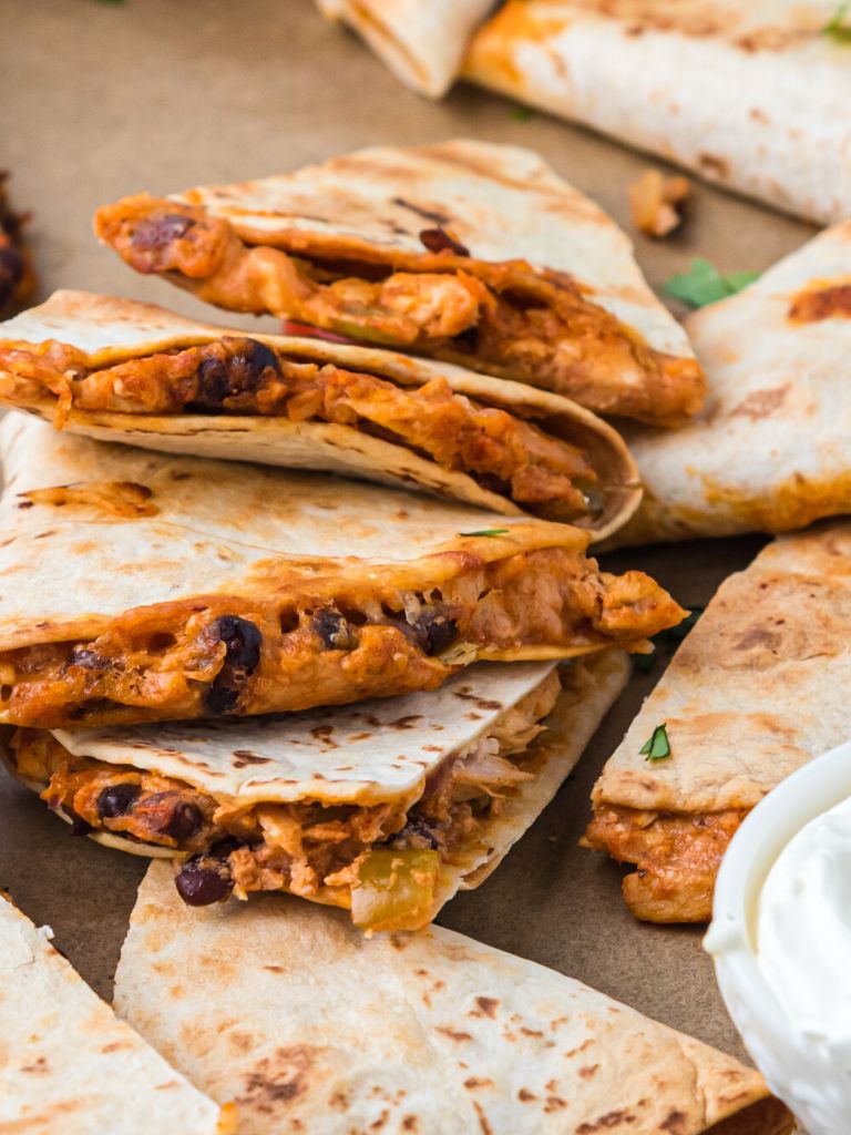 Sliced quesadillas on a pan showing the middle filling. 