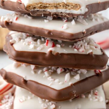 Stack of peppermint bark with graham cracker in the middle.