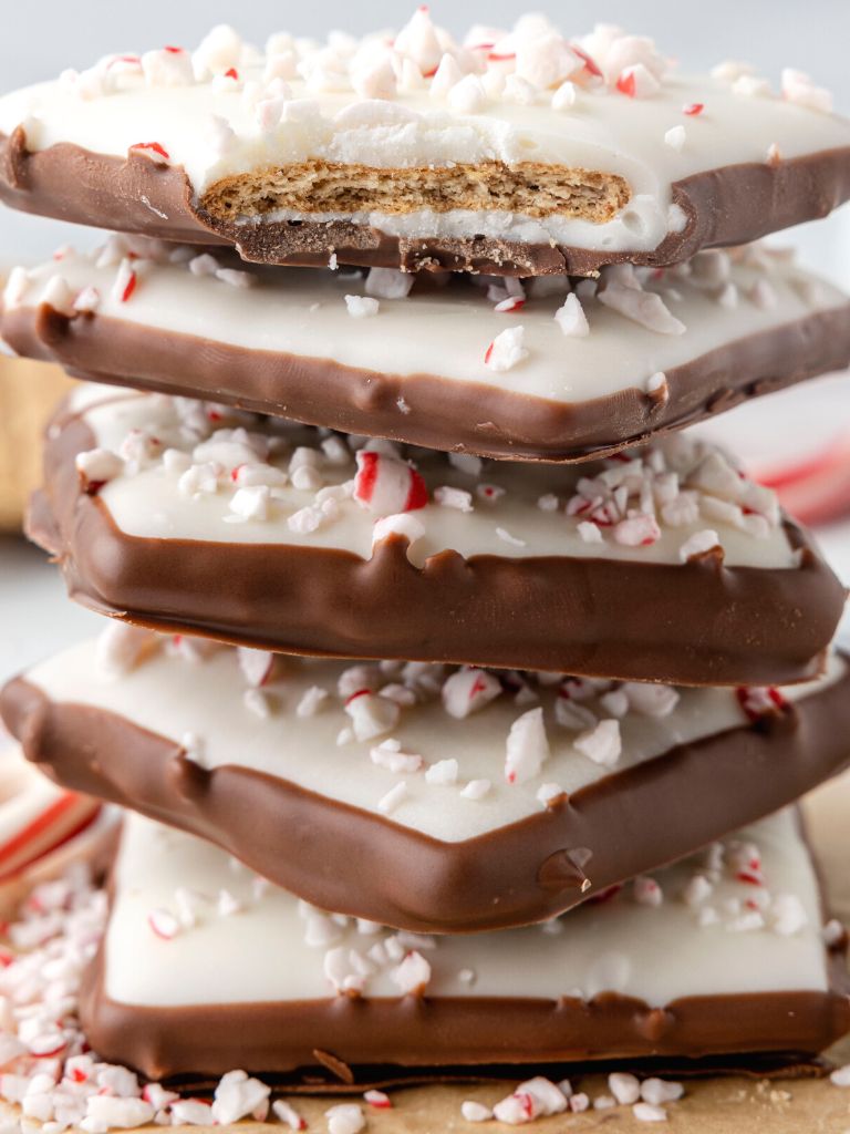 Stack of peppermint bark with graham cracker in the middle. 