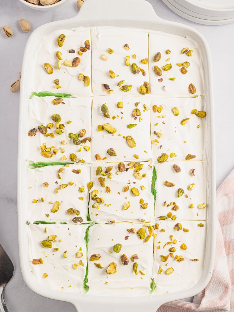 A pan of dessert topped with pistachios