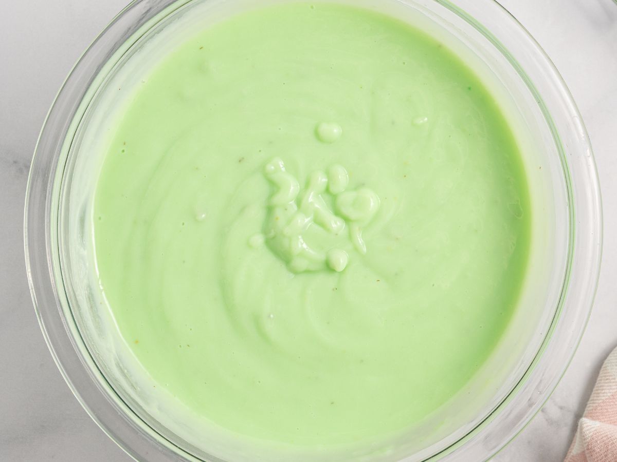 A bowl of pistachio pudding that has been thickened and mixed with milk. 