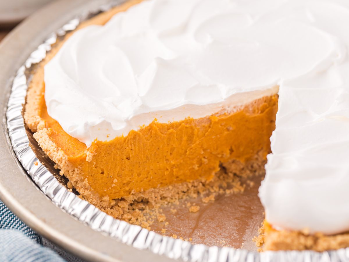 Horizontal photo of a slice of pie with a bite taken out the front of it with a fork.