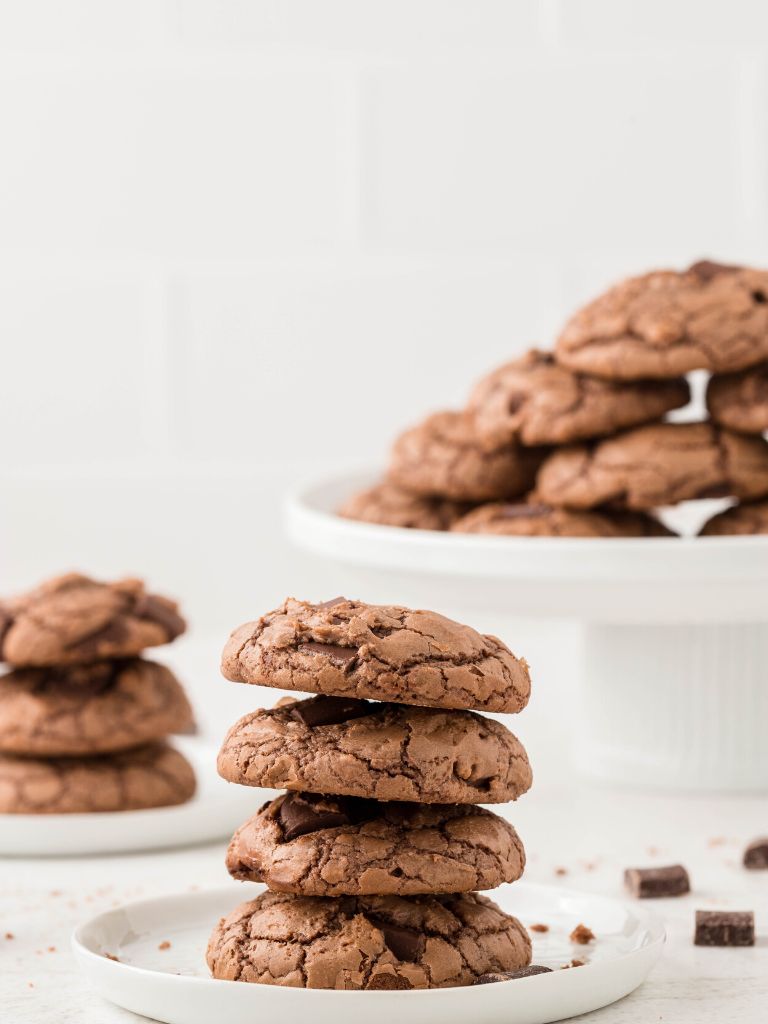Stack of cookies with a background of cookies on a platter. 