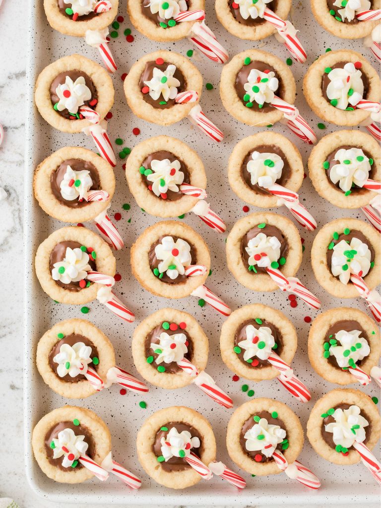 Overhead picture of hot cocoa cookie cups on a cookie sheet. 