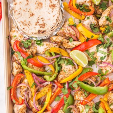 Tortillas on a sheet pan with bell peppers and chicken. Cooked in the oven.
