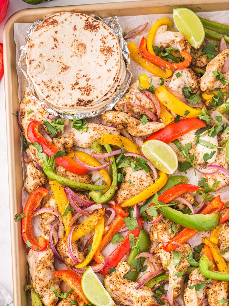 Tortillas on a sheet pan with bell peppers and chicken. Cooked in the oven. 