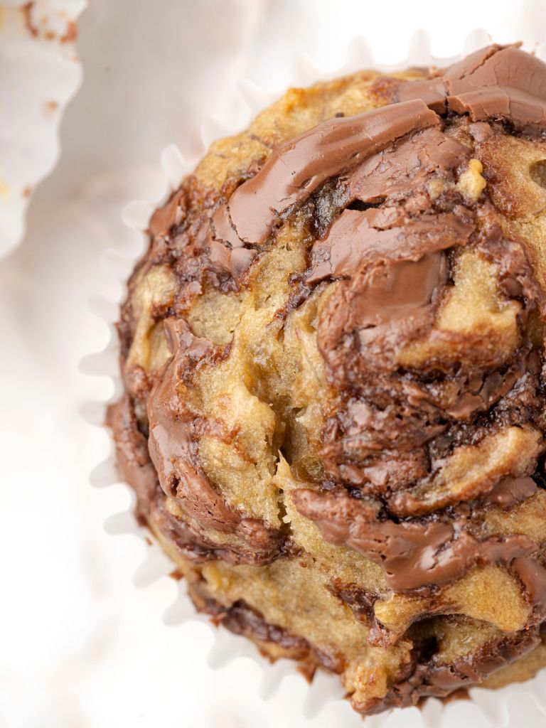 Top view of a muffin with Nutella swirls throughout. 
