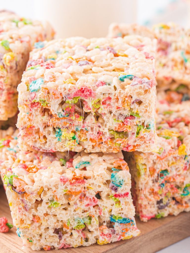 Stack of krispie treats with fruity pebbles cereal.