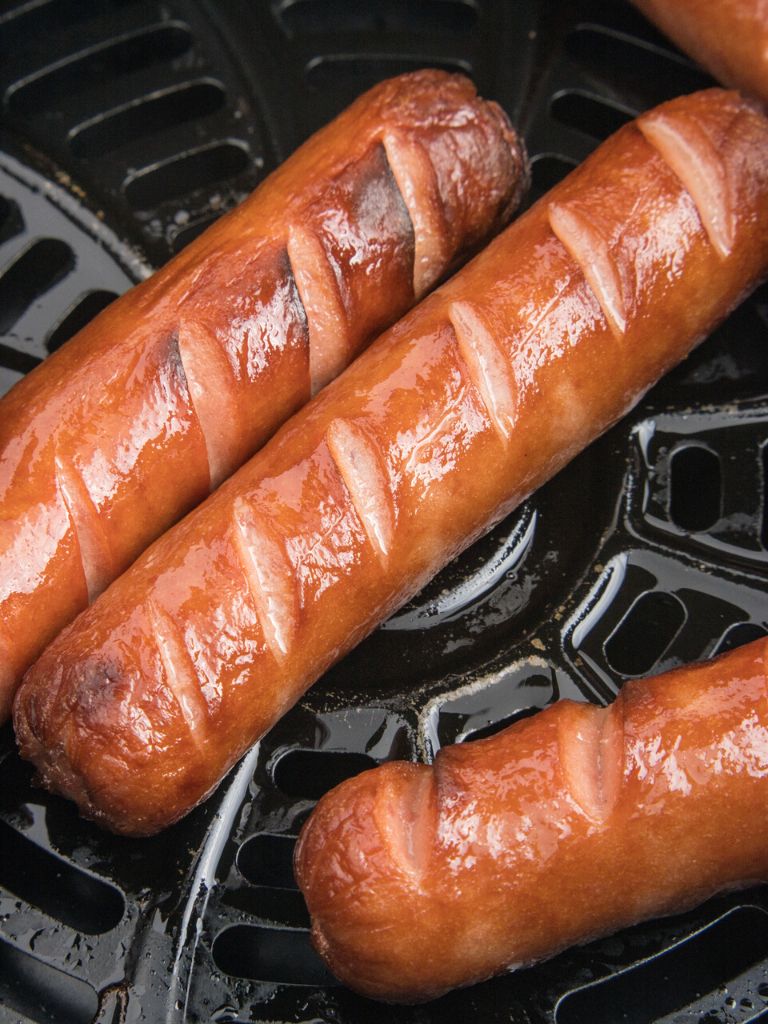 Hot dogs that are cooked inside the air fryer with slits on the top for the best cooking technique. 