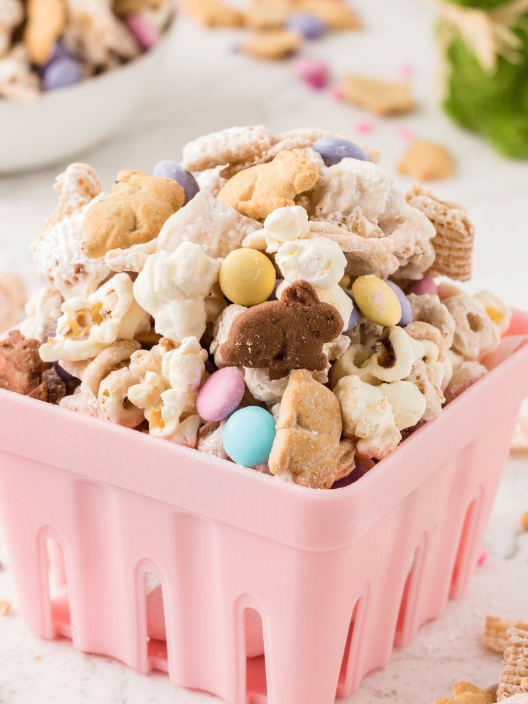 Trail mix for easter inside a pink basket. 
