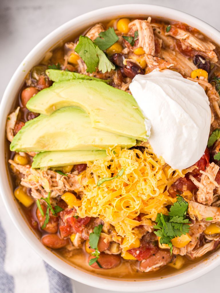 Overhead shot of this soup recipe with taco flavors and topped with sour cream and cheese. 