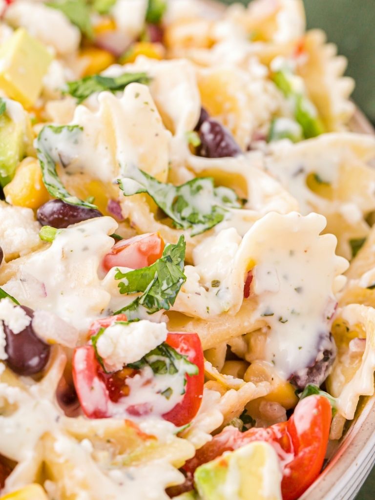 Close up of the pasta salad with the avocado dressing poured over it