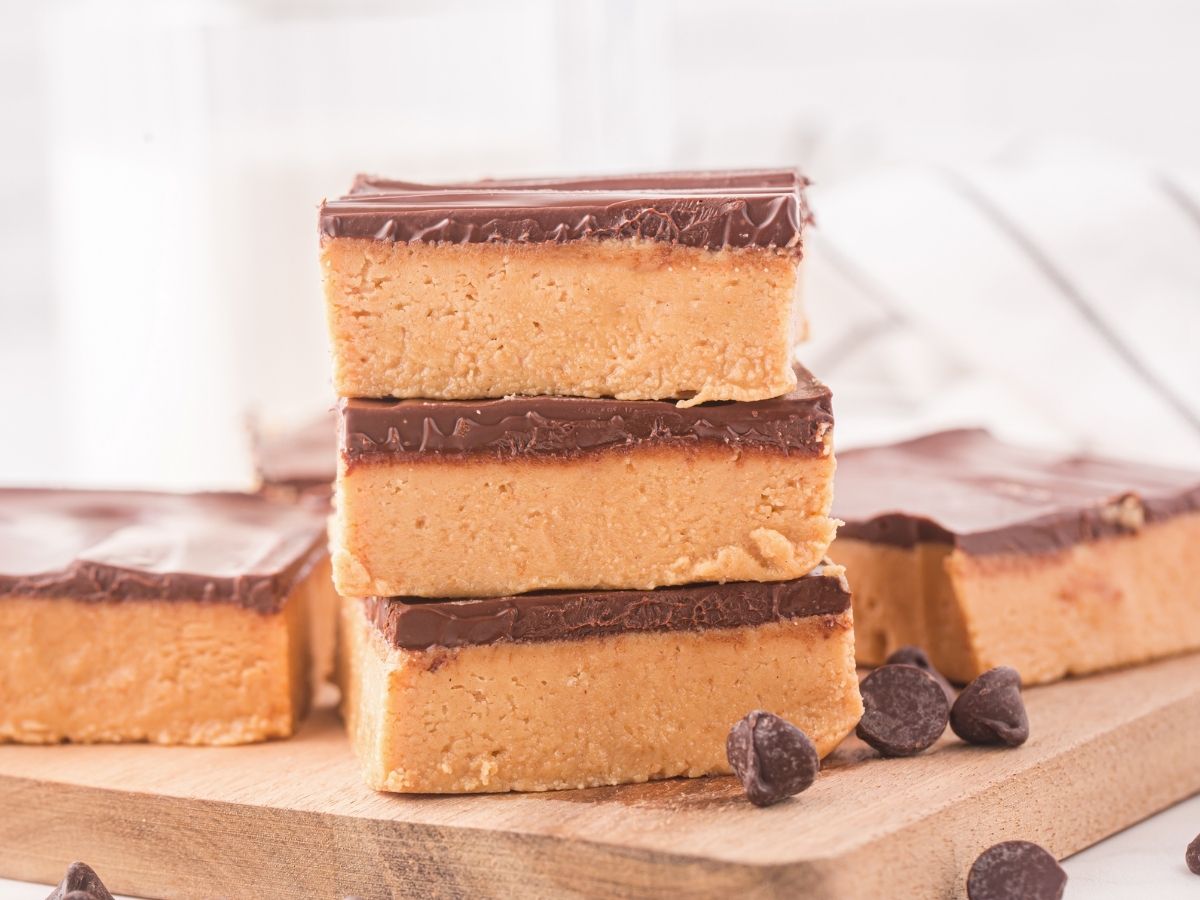 Stack of peanut butter chocolate bars with chocolate chips around them