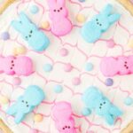 Overhead photo of a cookie pizza with peeps on it.