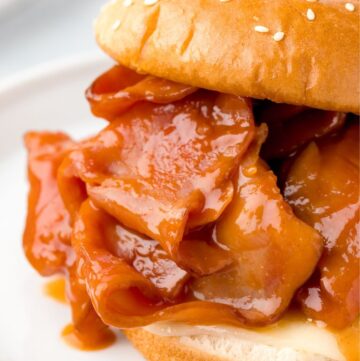 A photo of this recipe on a white plate showing the sliced ham and sauce.