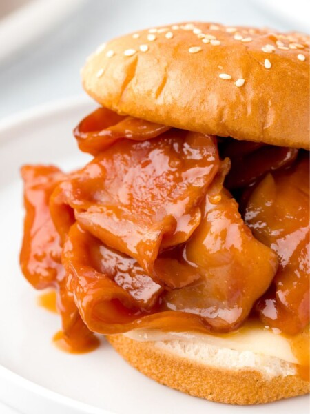A photo of this recipe on a white plate showing the sliced ham and sauce.