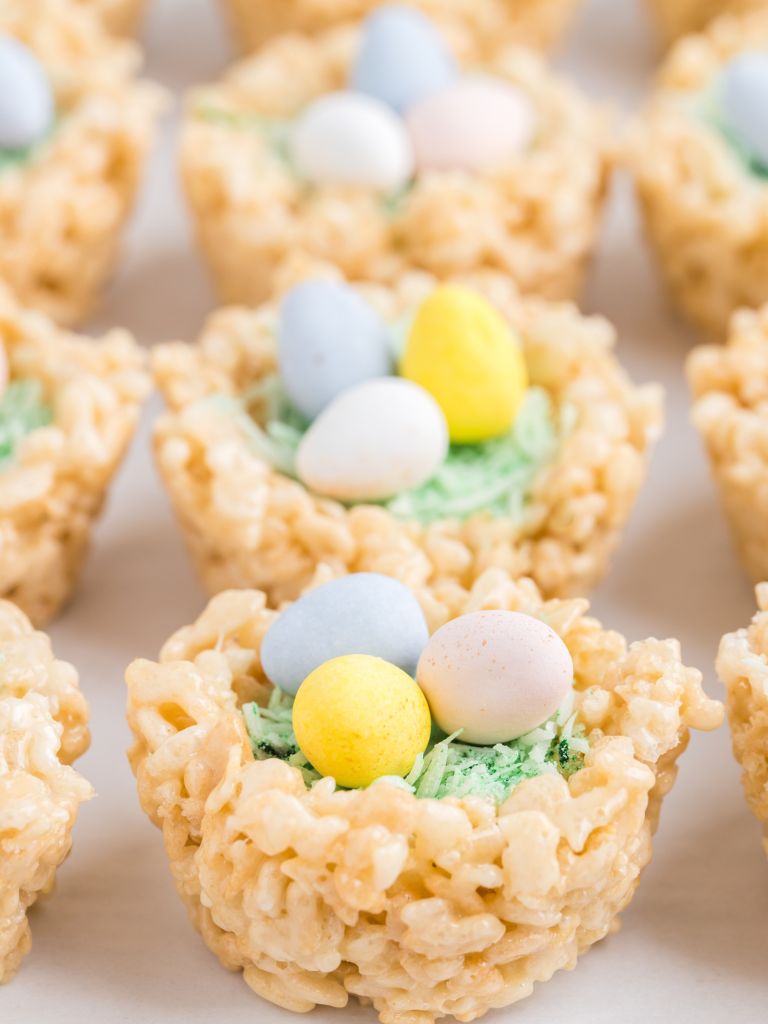 easter egg nests with mini eggs, coconut grass, and krispie treats. 