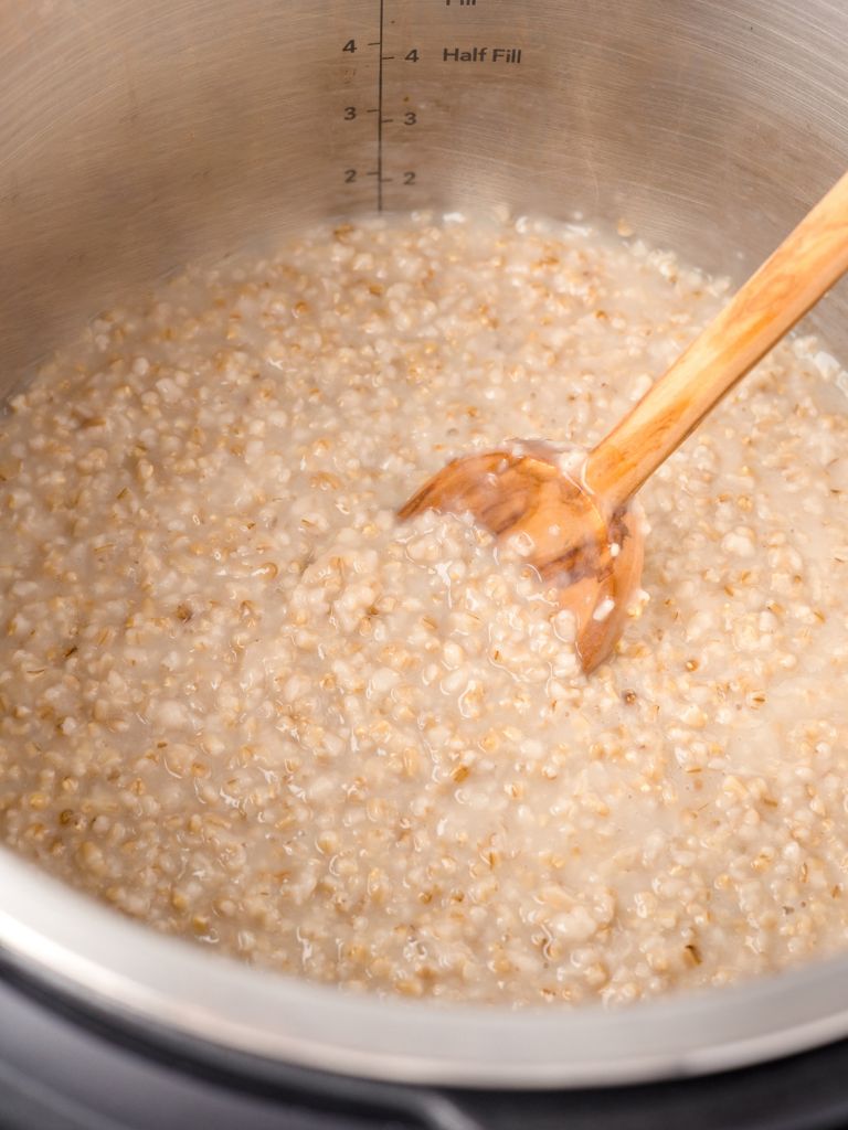 A instant pot insert full of cooked oats.