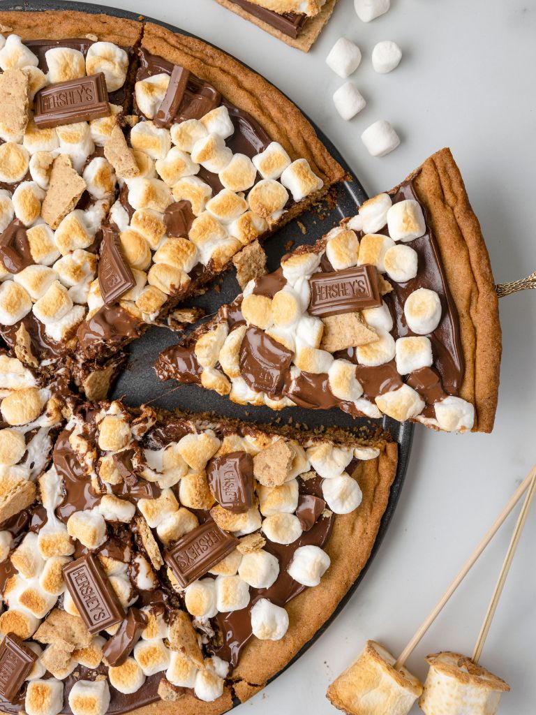 Overhead photo of the cookie pizza with a slice of serving spoon. 