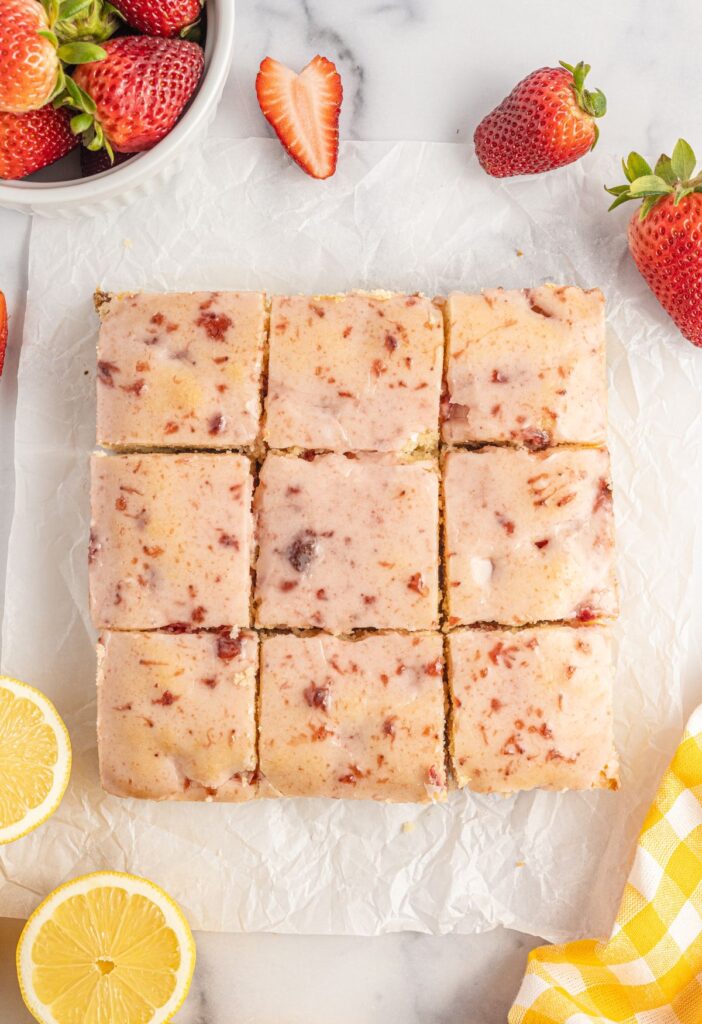 Overhead shot of the bars with lemon and sliced strawberry around them. 