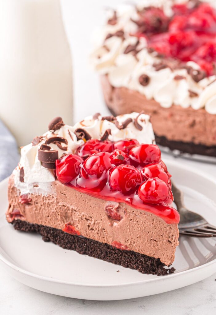 A piece of this Black Forest cheesecake ready for eating. 