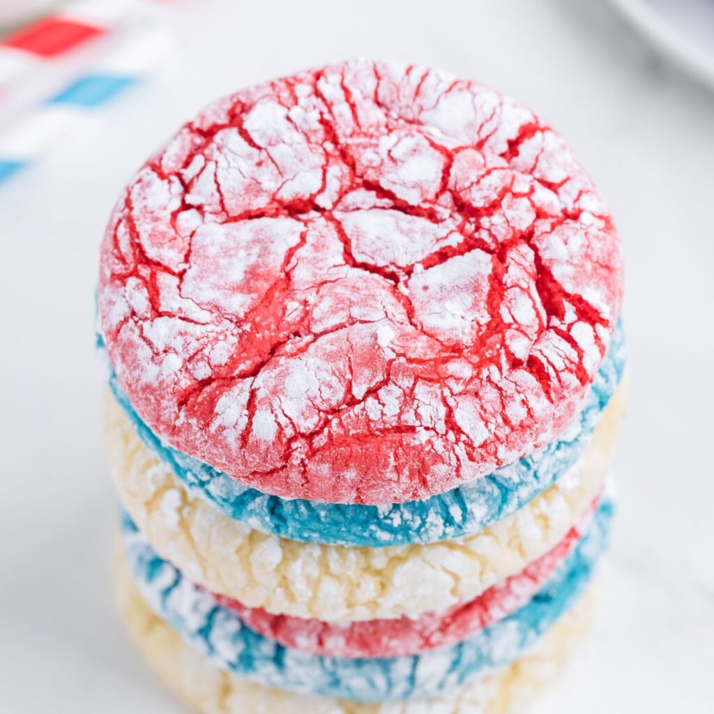 A stack of cookies with a red cookie at the top. 