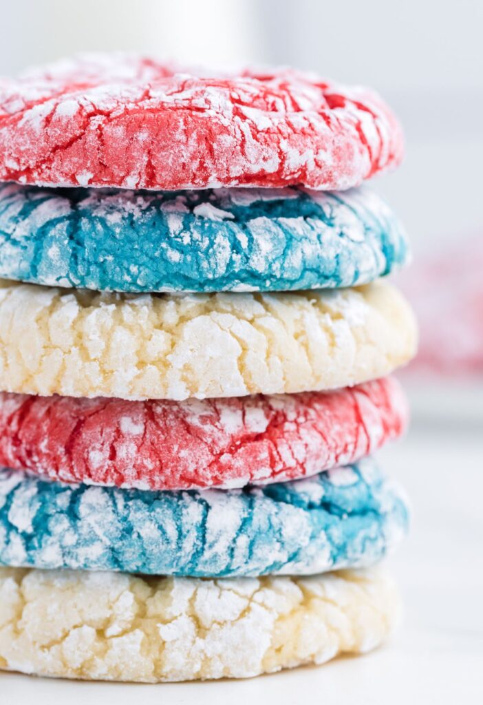Stack of red, blue, and white cookies with powdered sugar 