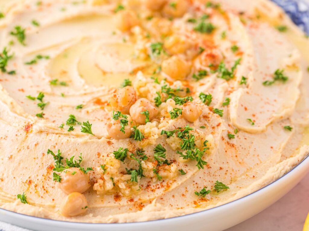Step by step photos showing how to make this dip recipe with roasted garlic and tahini.